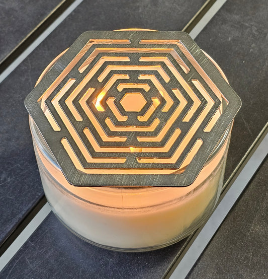 Hexagon stainless steel candle topper on jar candle – modern geometric candle accessory.