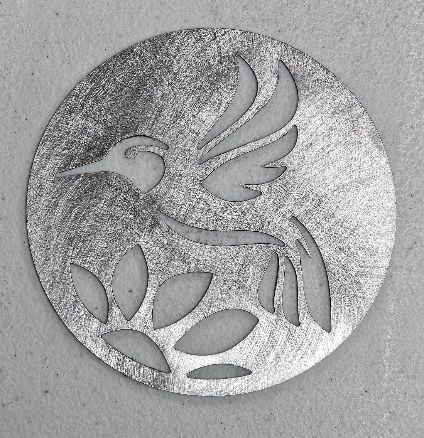 Hummingbird metal candle topper on 3-wick candle with cutout leaf design