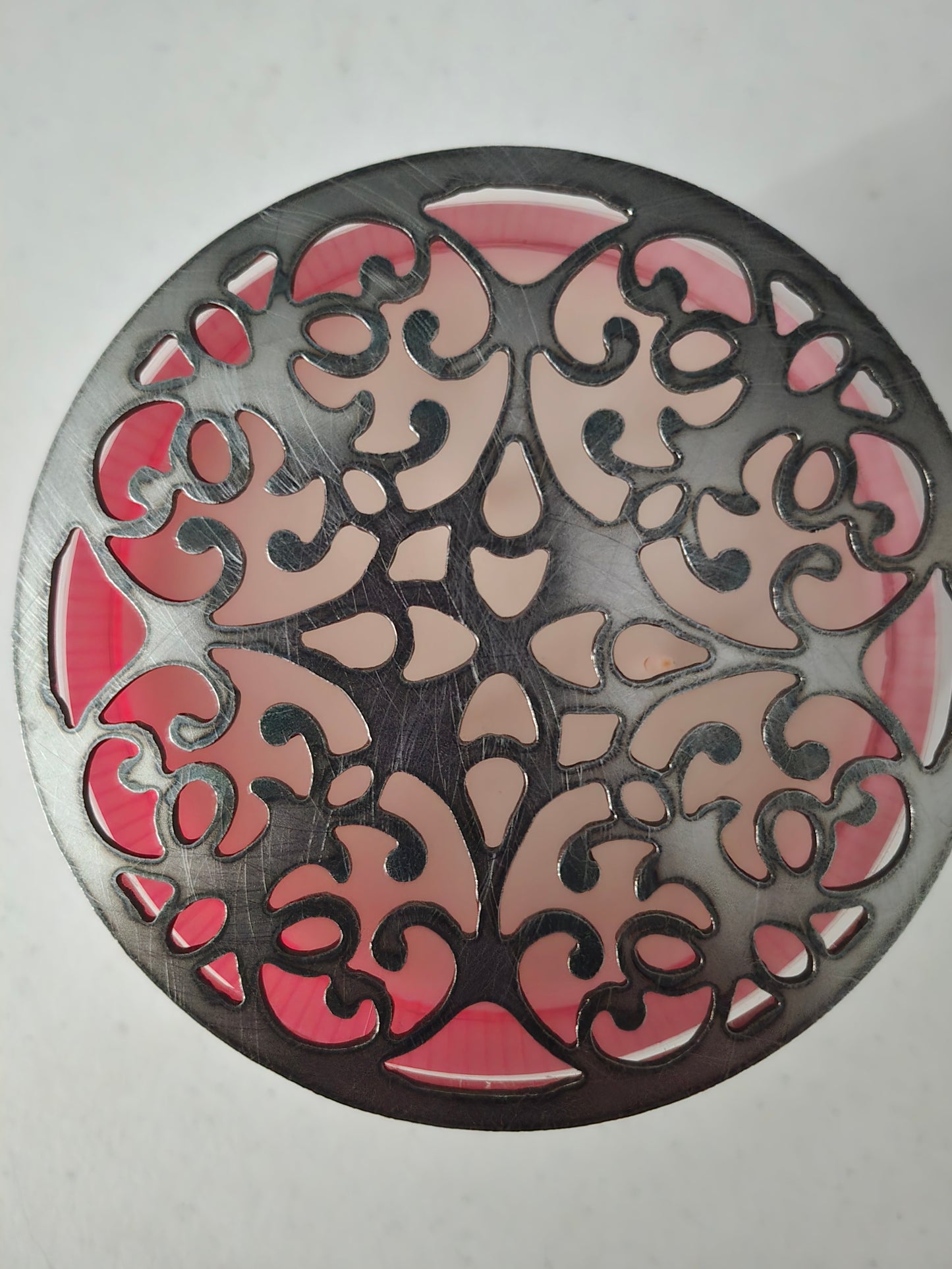 Floral metal candle lid topper close-up