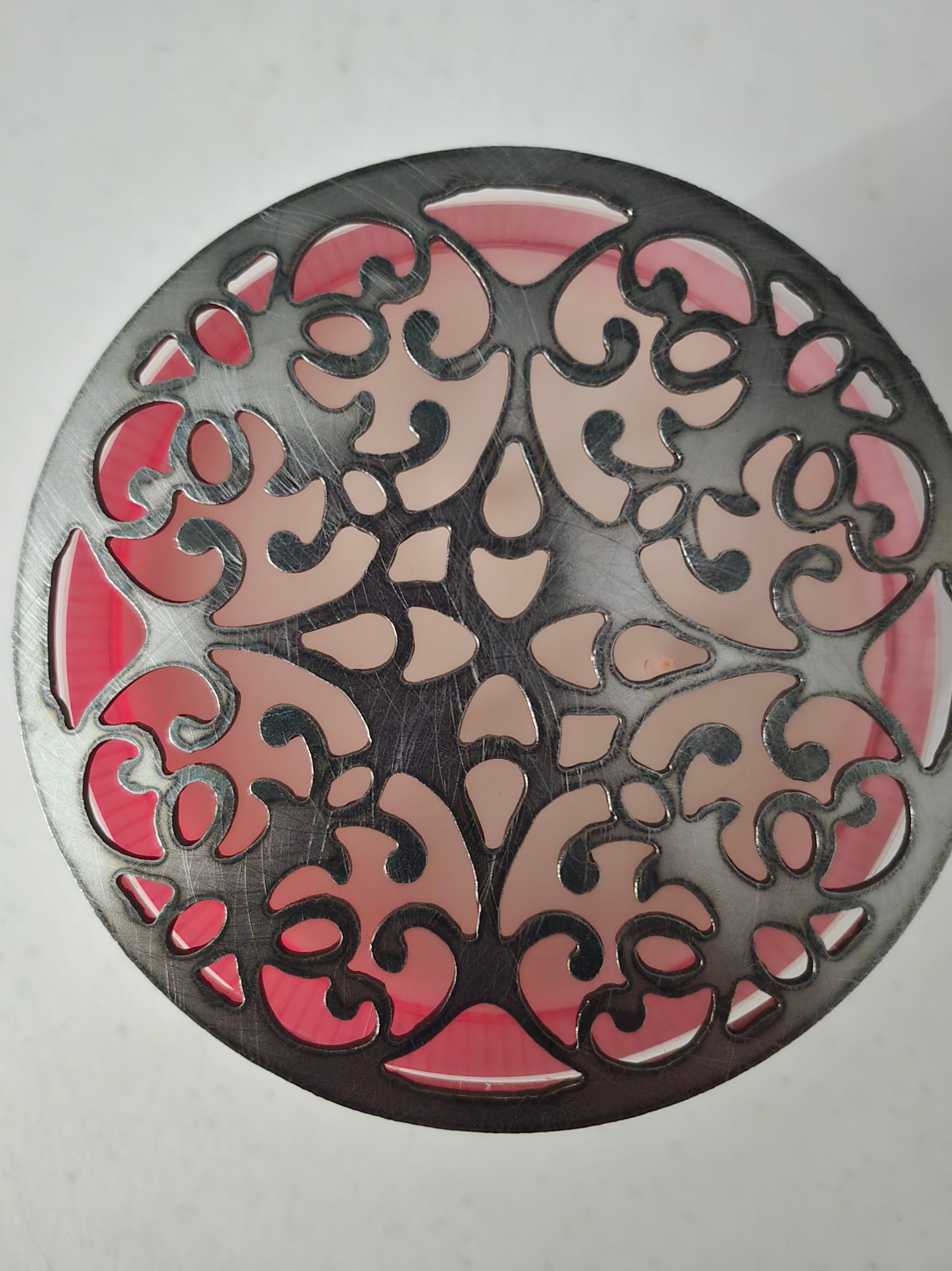 Floral metal candle lid topper close-up