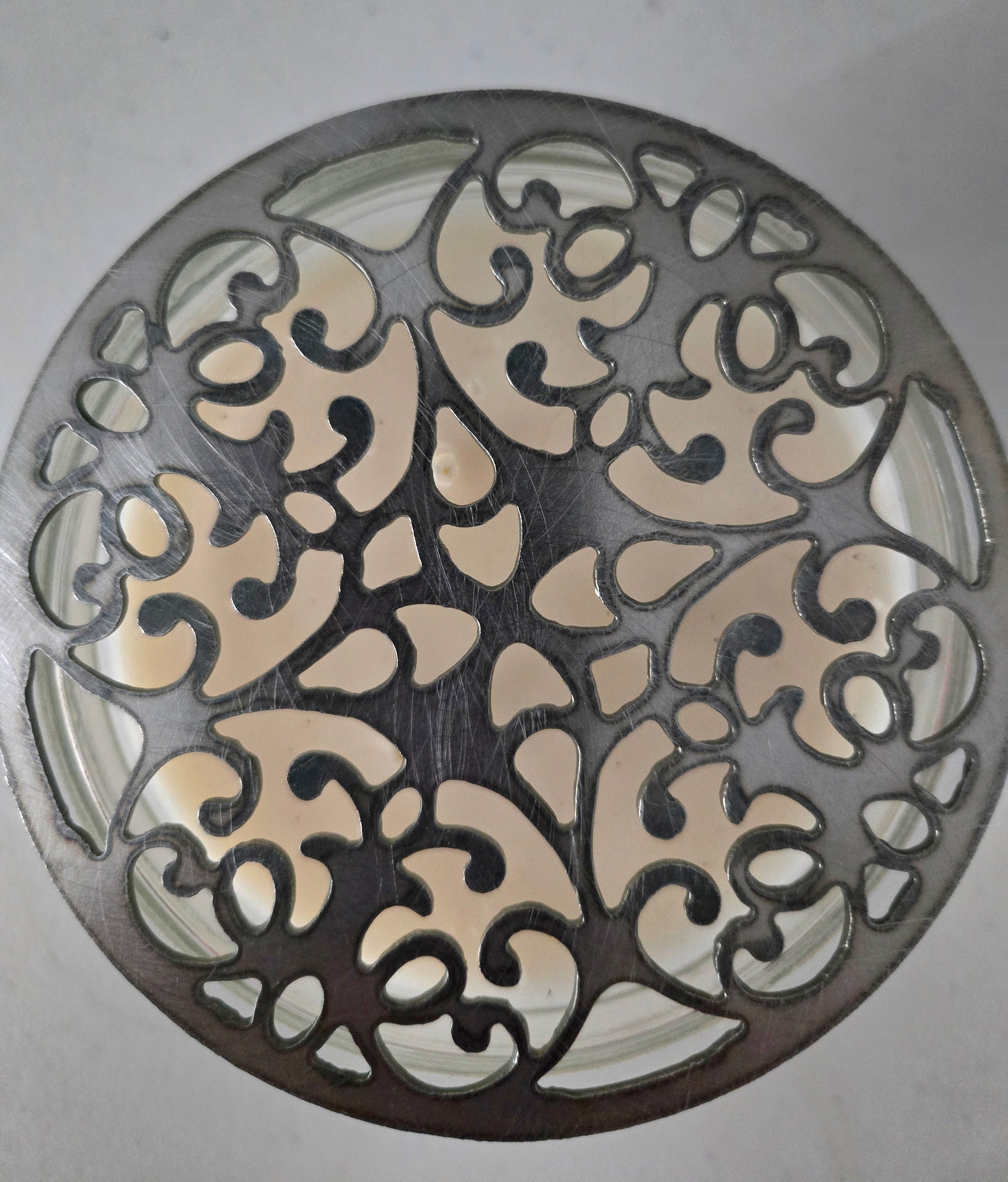 Floral metal candle lid topper close-up