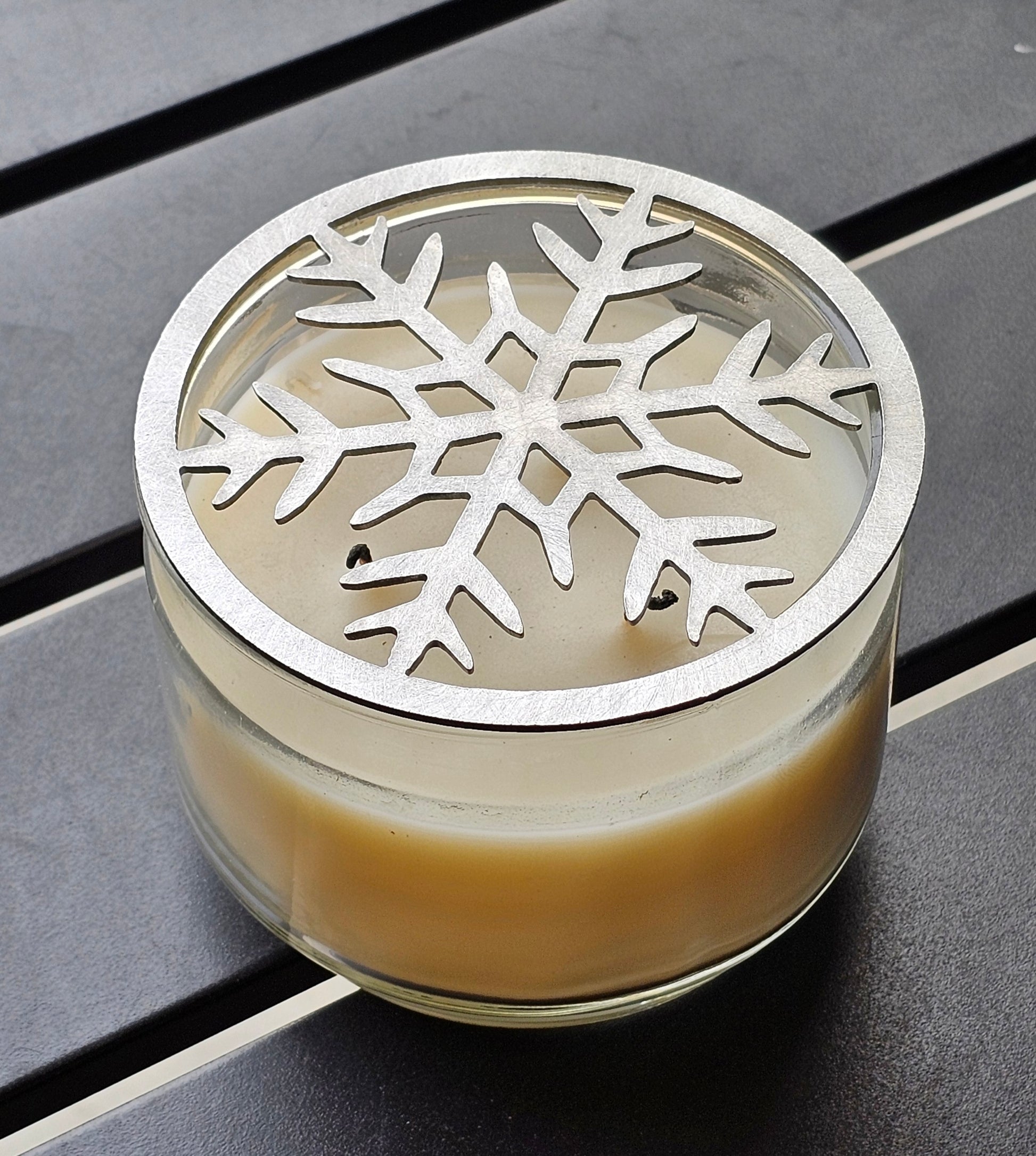 Frosted metal snowflake candle topper on jar candle for Christmas decor
