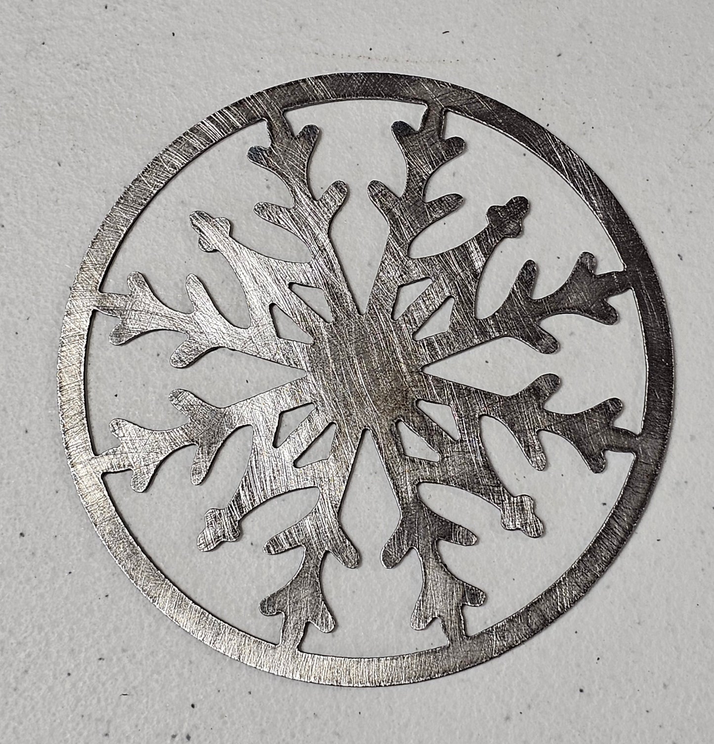 Decorative snowflake candle topper for even burn