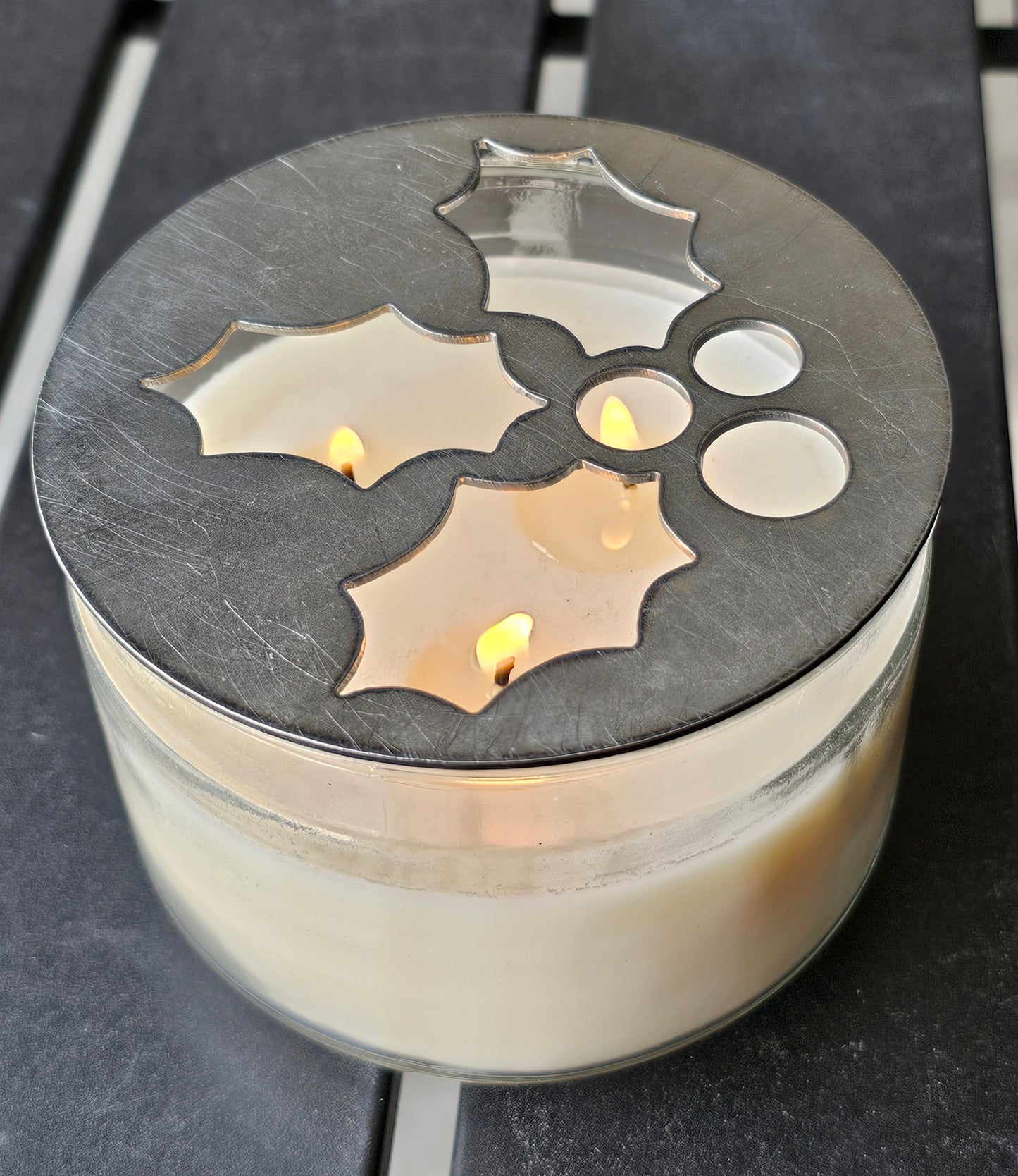 Mistletoe holly berry metal candle topper placed on white jar candle