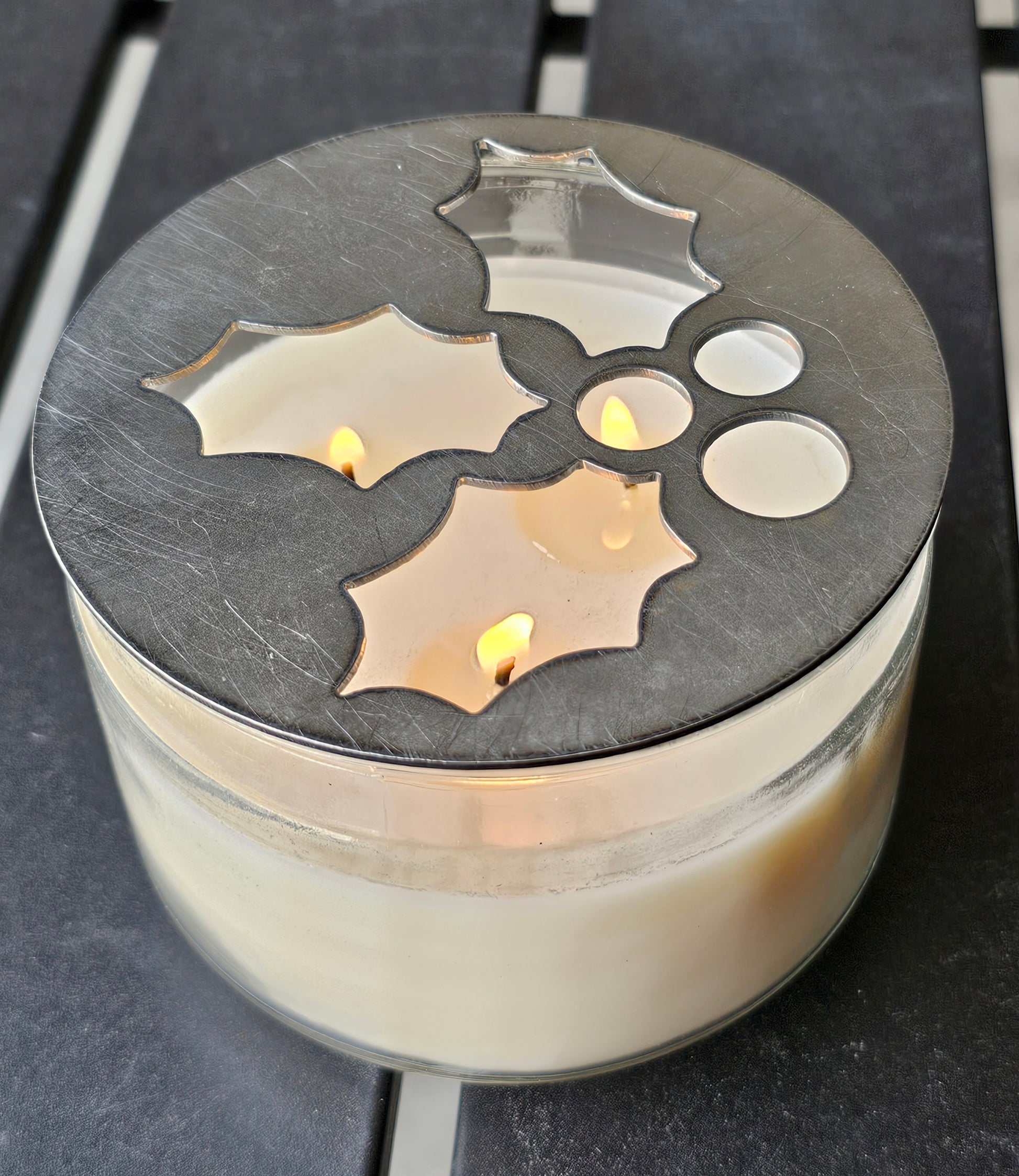 Mistletoe holly berry metal candle topper placed on white jar candle