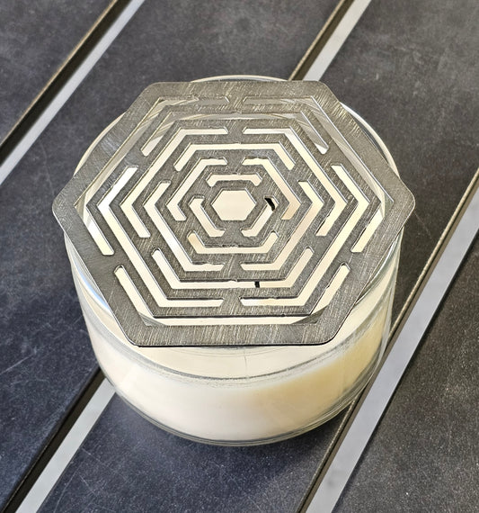 Hexagon stainless steel candle topper on jar candle – modern geometric candle accessory.