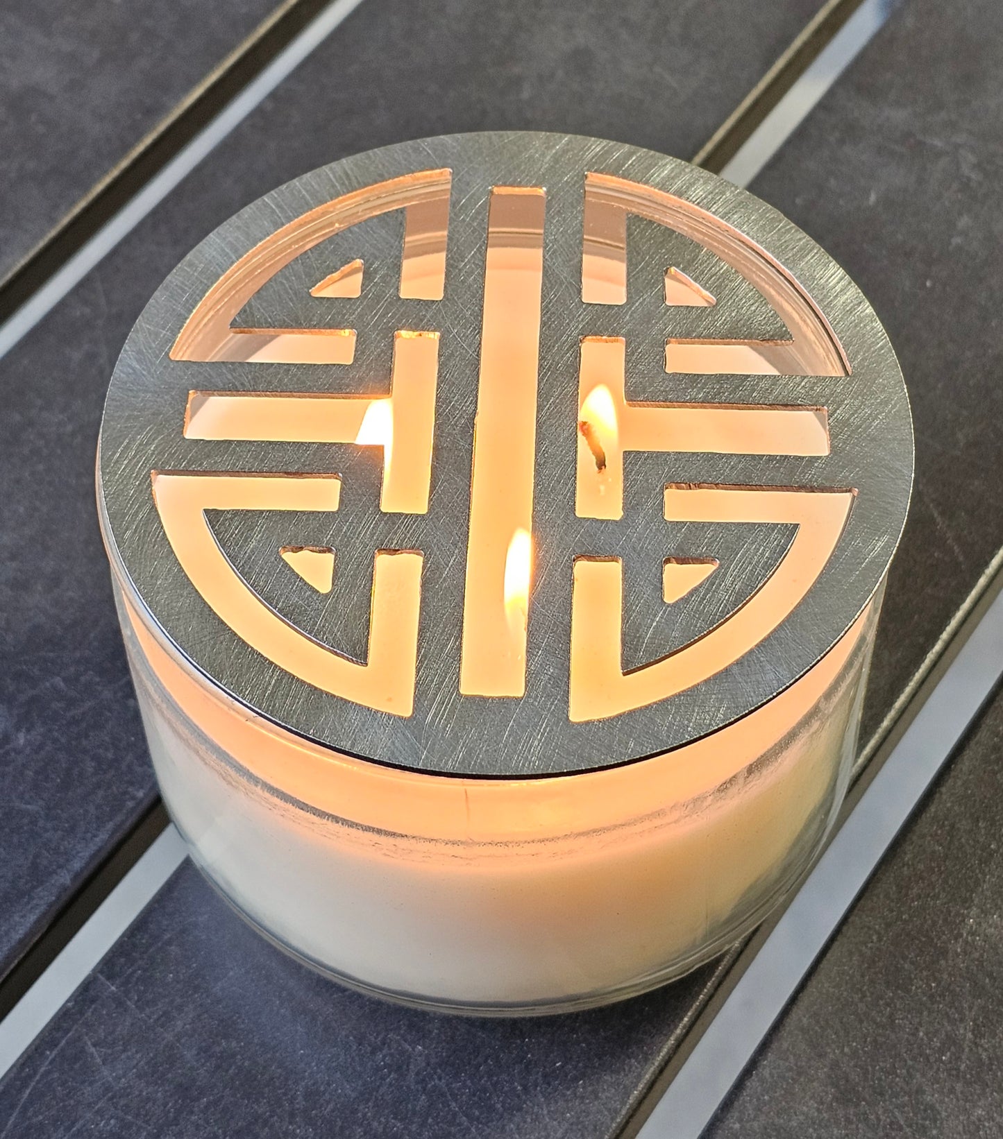 Double Happiness Glow candle topper in black ceramic finish on a candle