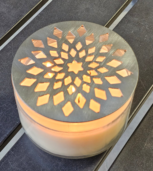Decorative candle holder with geometric pattern on a dark surface
