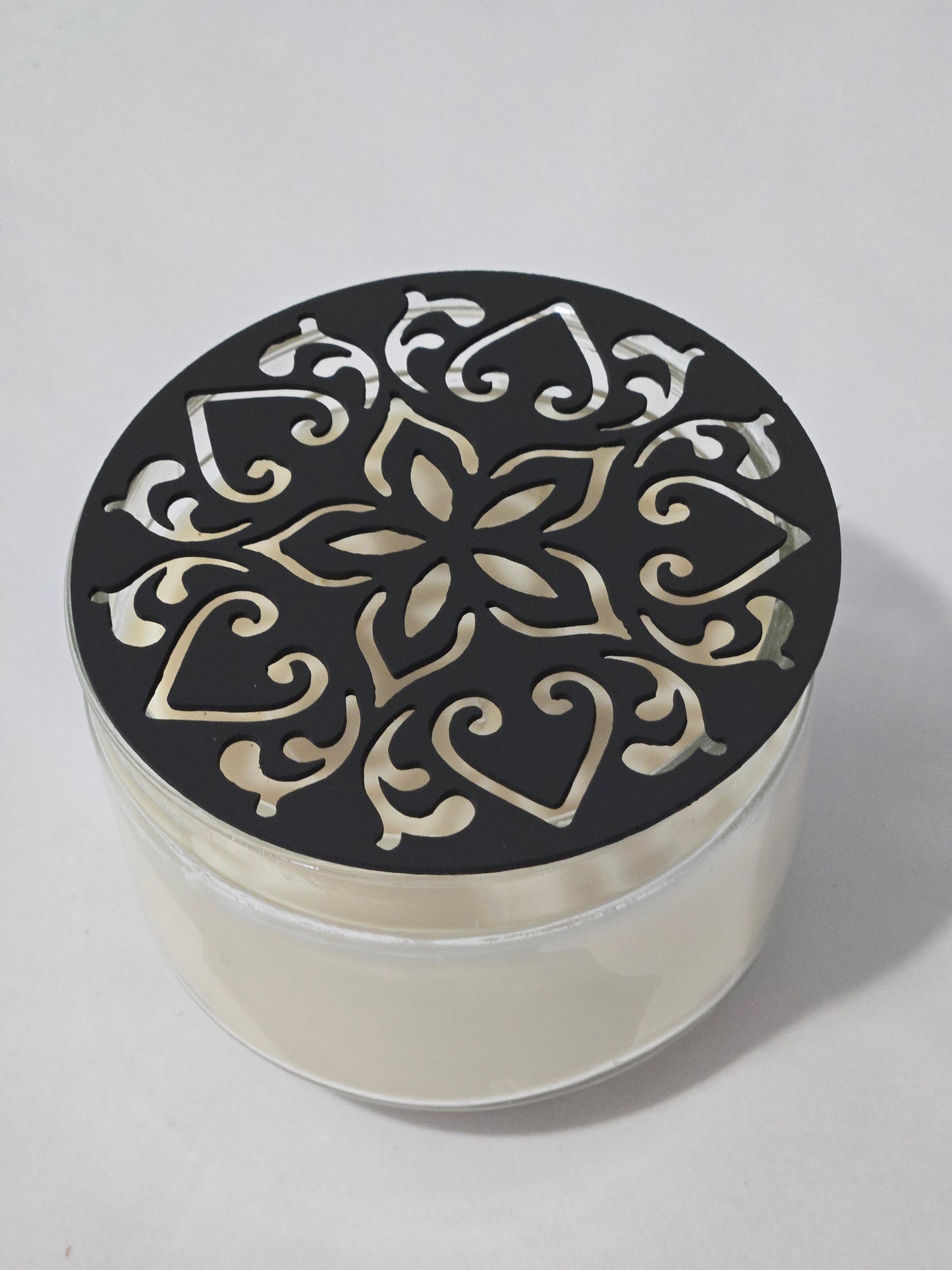 Metal floral star candle topper on jar candle for farmhouse decor