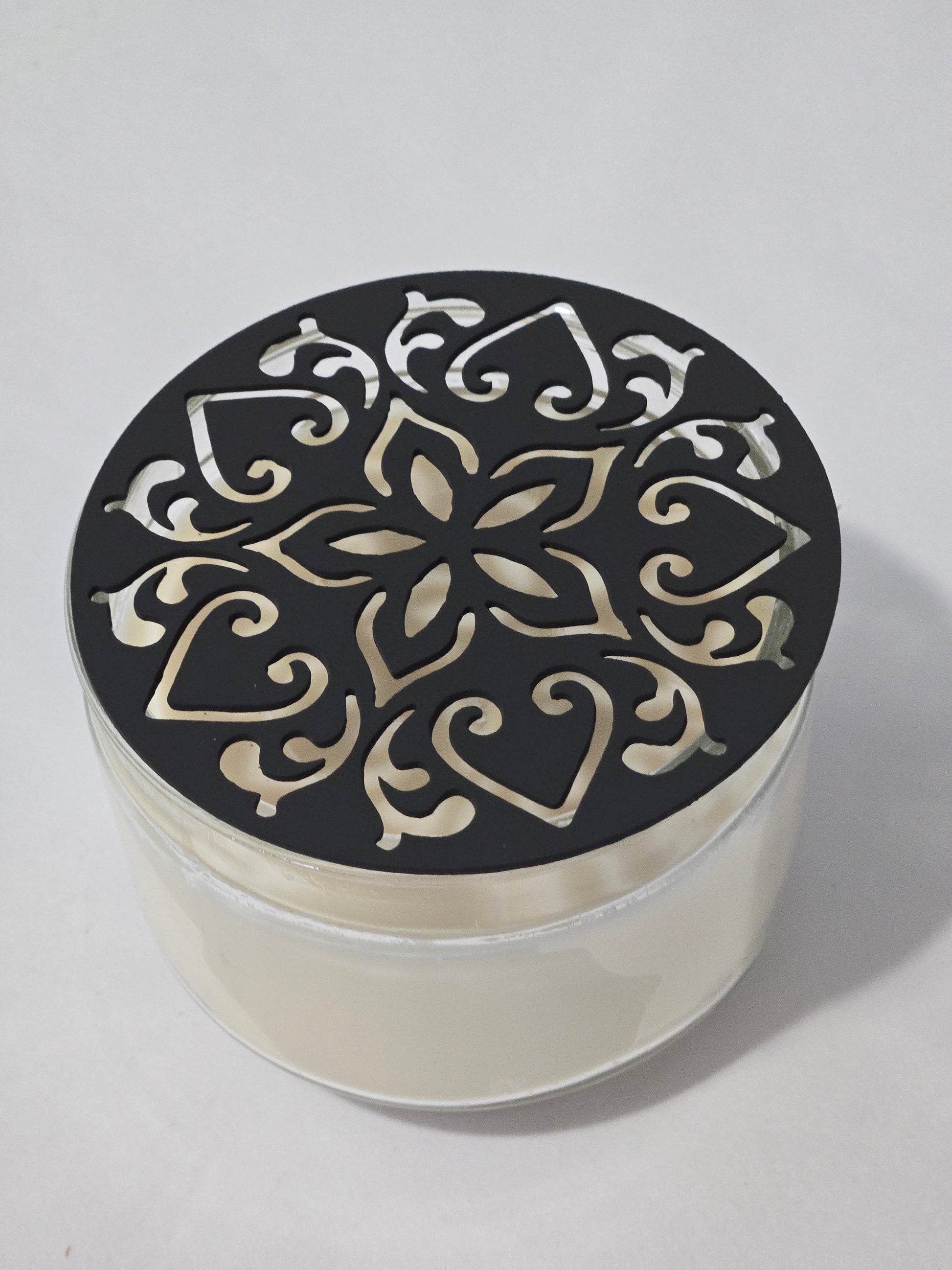 Metal floral star candle topper on jar candle for farmhouse decor