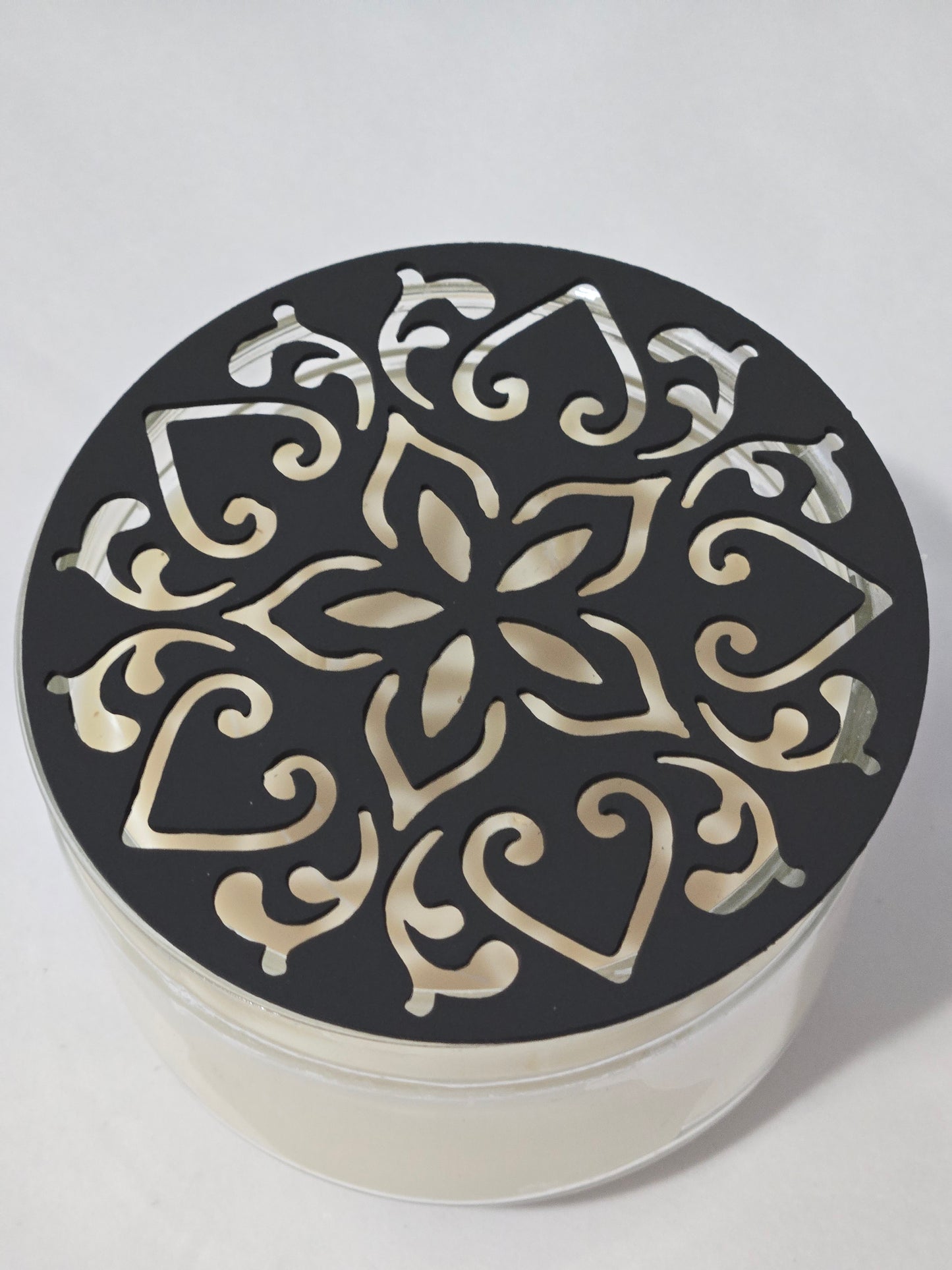 Metal floral star candle topper on jar candle for farmhouse decor