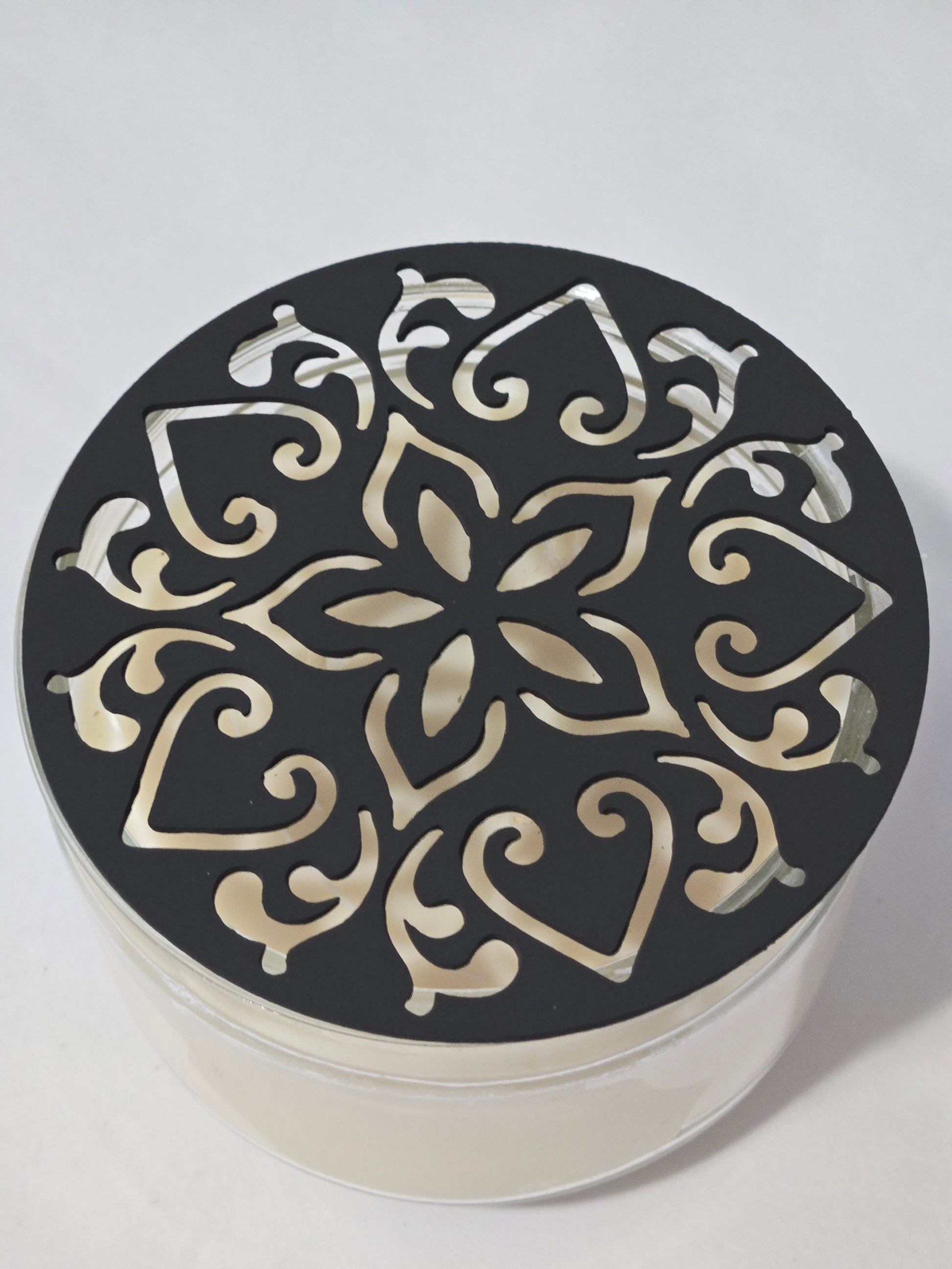 Metal floral star candle topper on jar candle for farmhouse decor