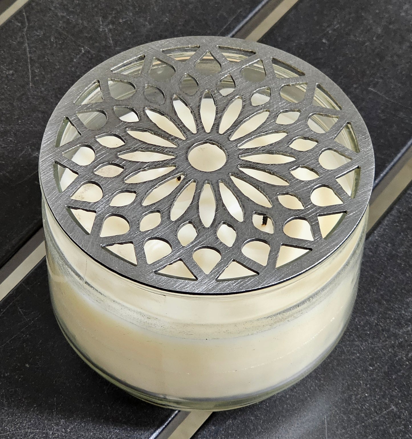 Decorative metal candle topper reducing smoke