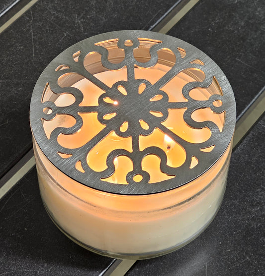 Victorian Scroll metal candle topper on a lit jar candle featuring ornate vintage scrollwork design