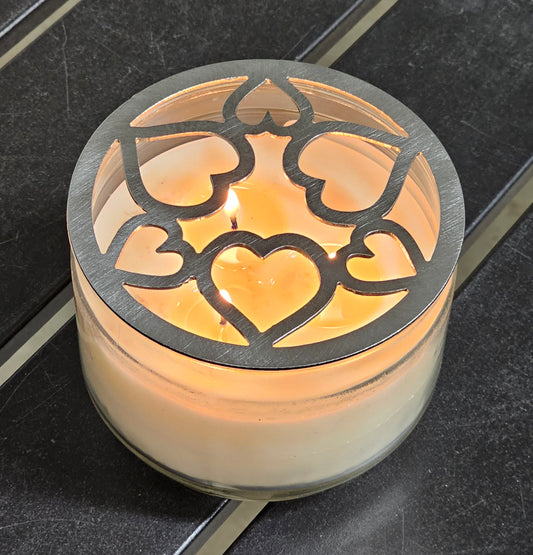 Tangled Hearts metal candle topper featuring intertwined heart design on a lit jar candle