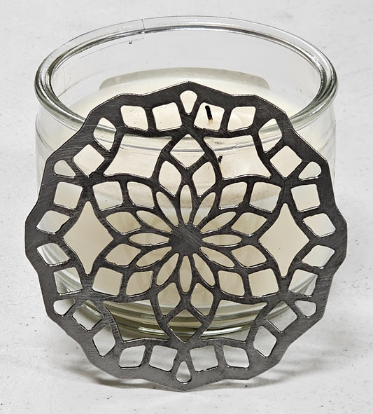 “Floral mandala metal candle topper on jar candle creating even burn and decorative light pattern”