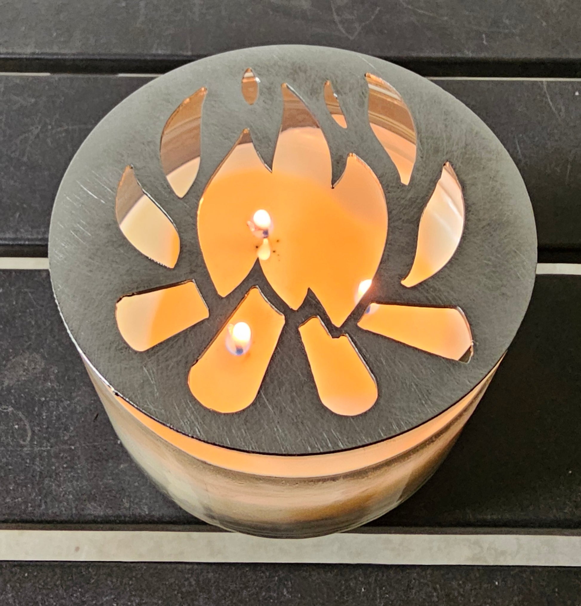 Flame design candle topper reducing soot