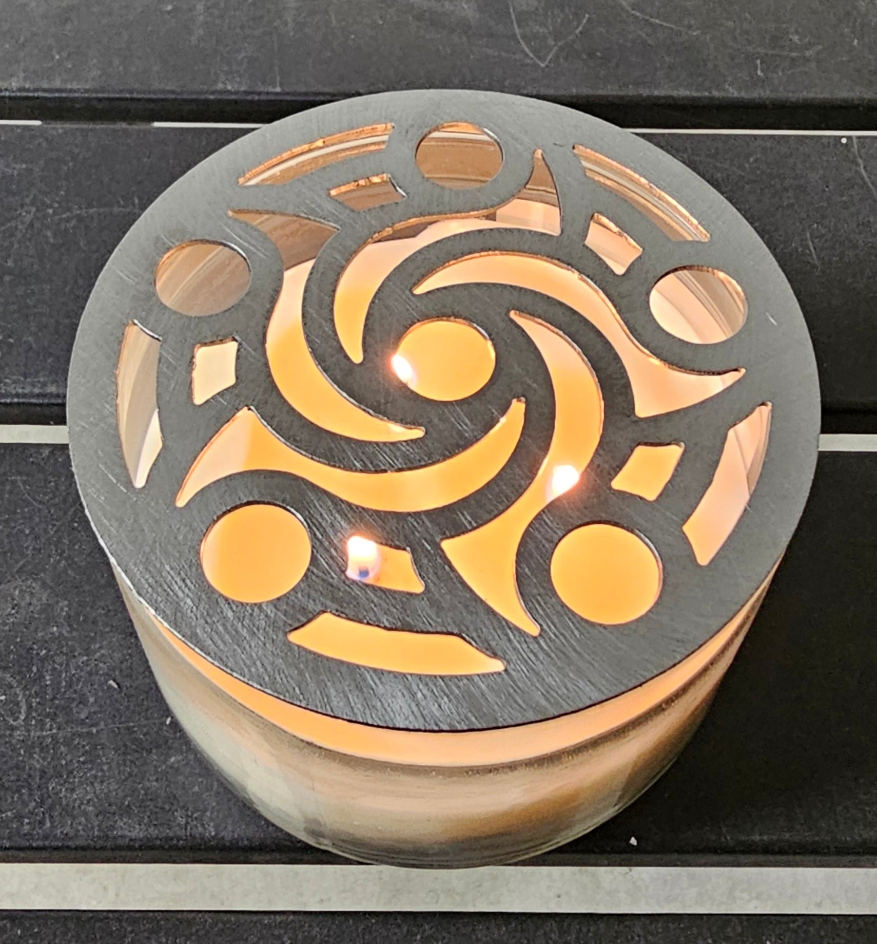 Metal candle topper helping prevent candle tunneling