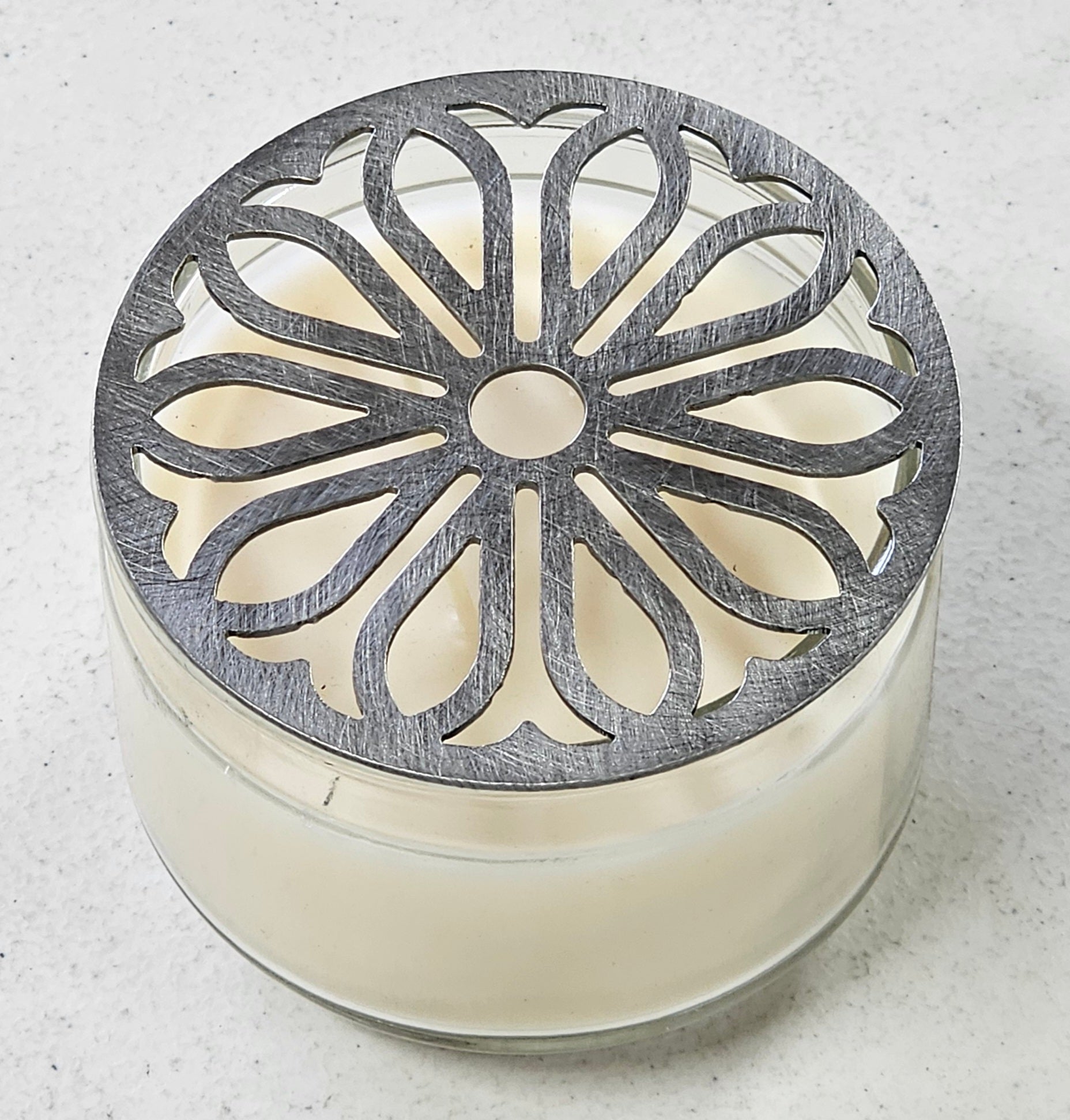Radiant Sunpetal metal candle topper on jar candle