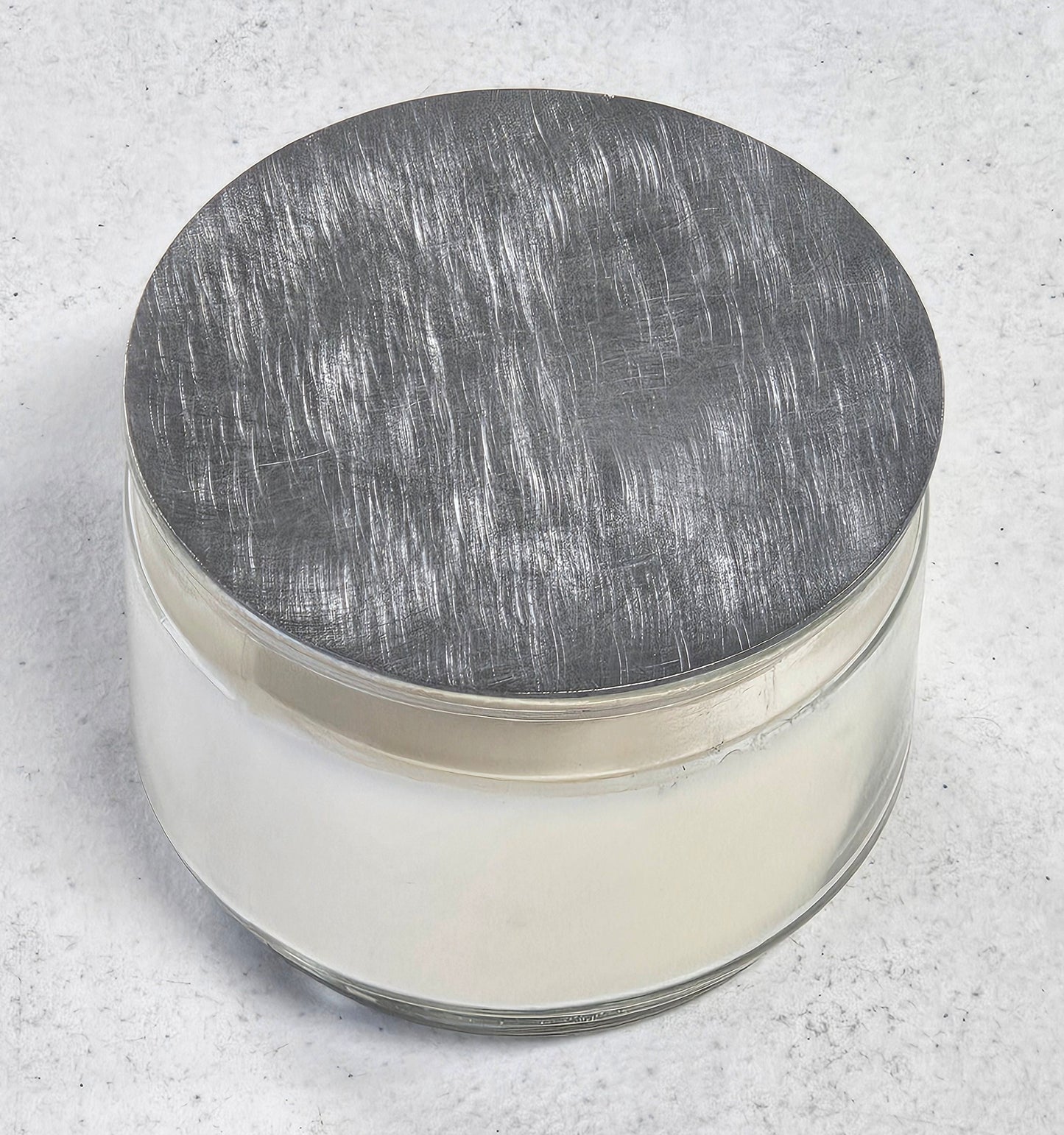 flat metal candle snuffer lid on jar candle