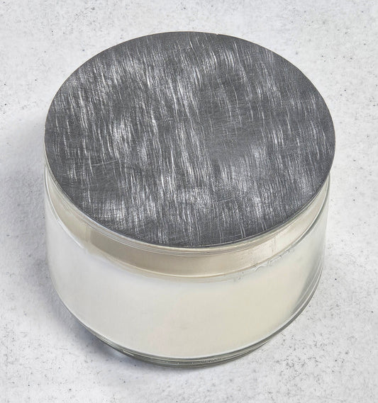 flat metal candle snuffer lid on jar candle