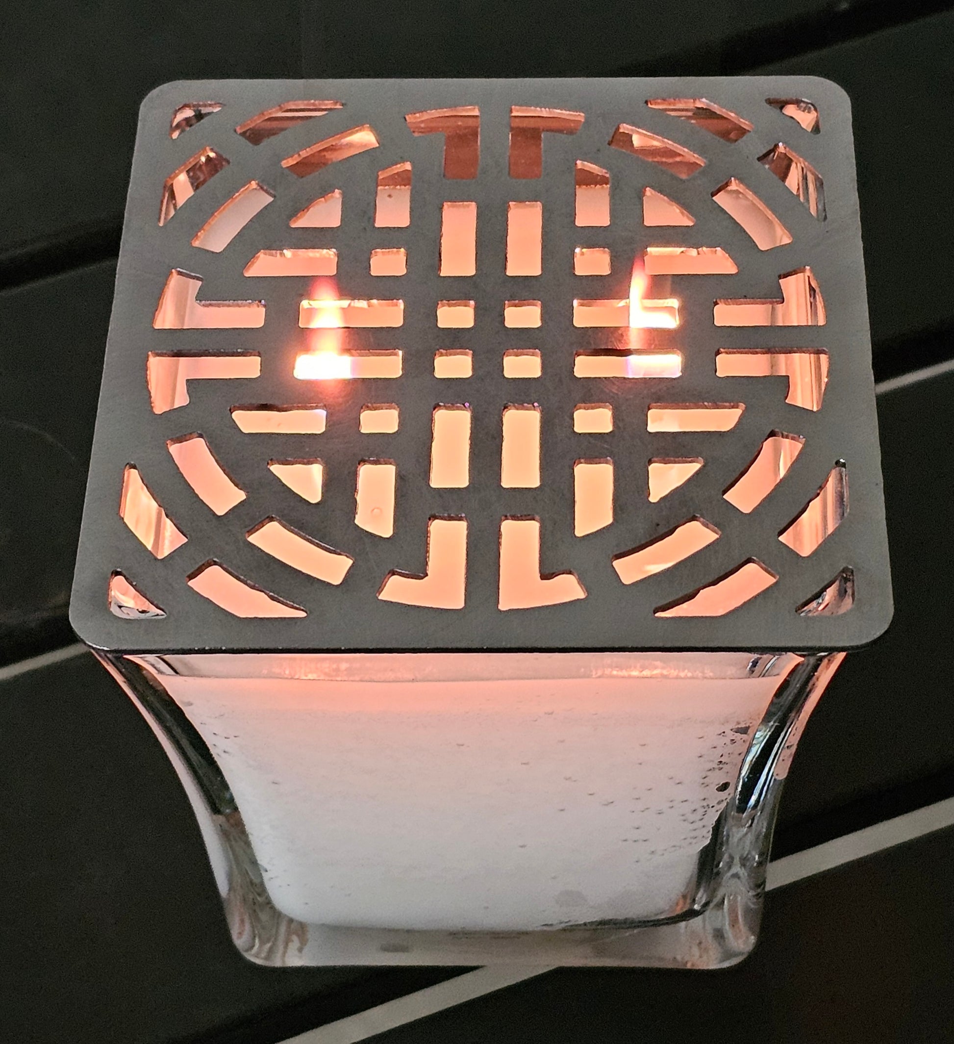 candle topper creating ambient light pattern