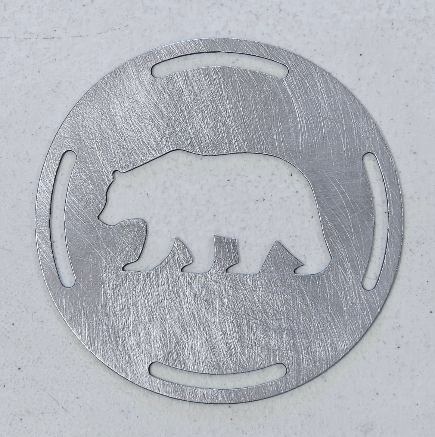 Rustic bear candle topper sitting flat on white jar candle showing wildlife silhouette design
