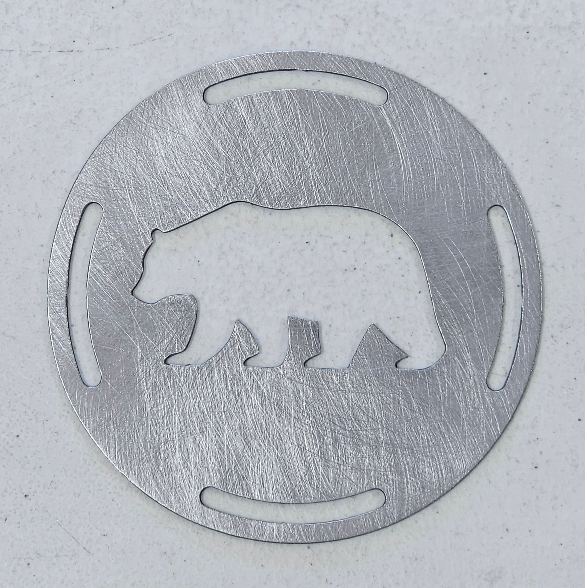 Rustic bear candle topper sitting flat on white jar candle showing wildlife silhouette design