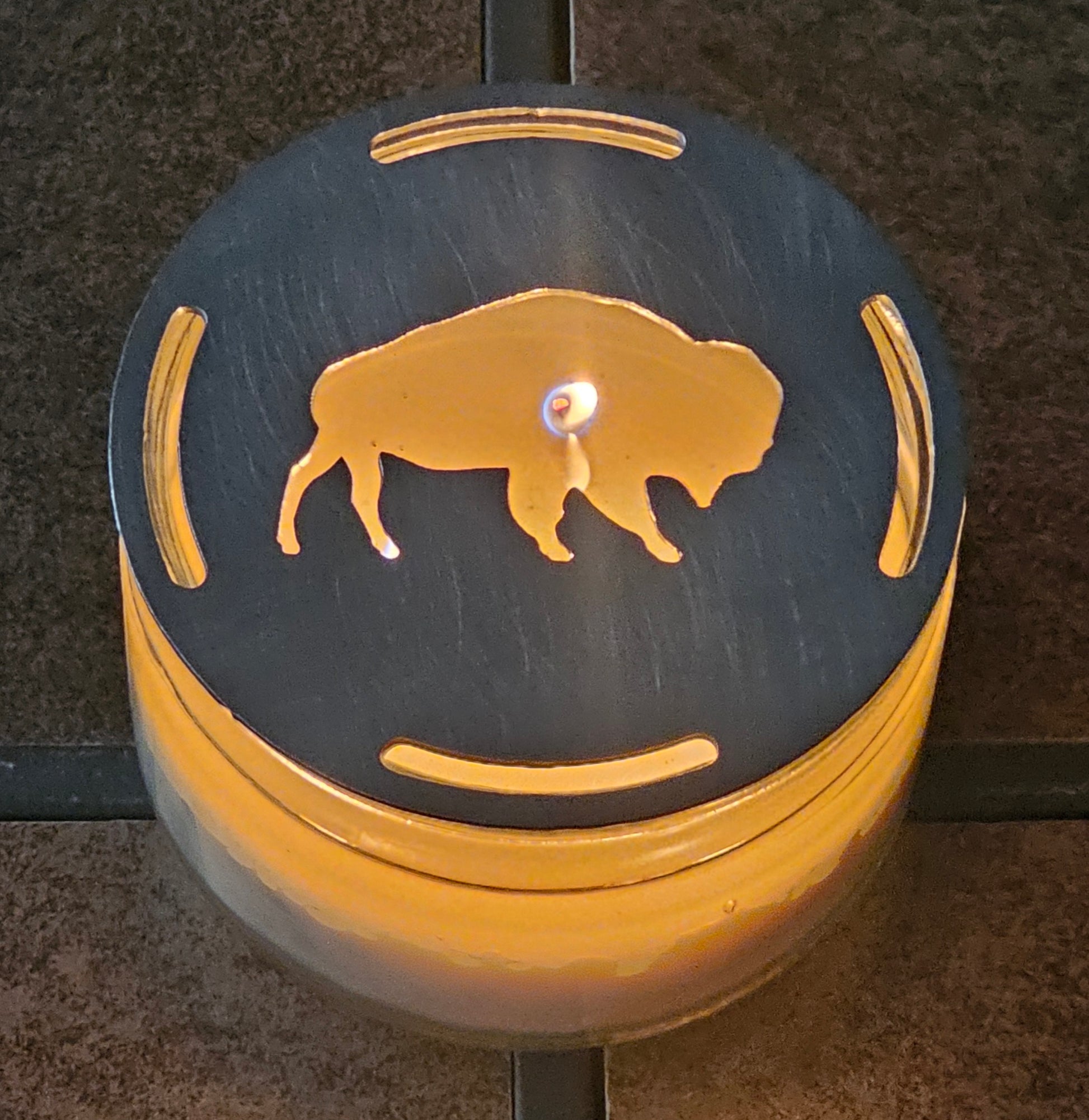  Buffalo candle topper on lit jar candle glowing with bison silhouette