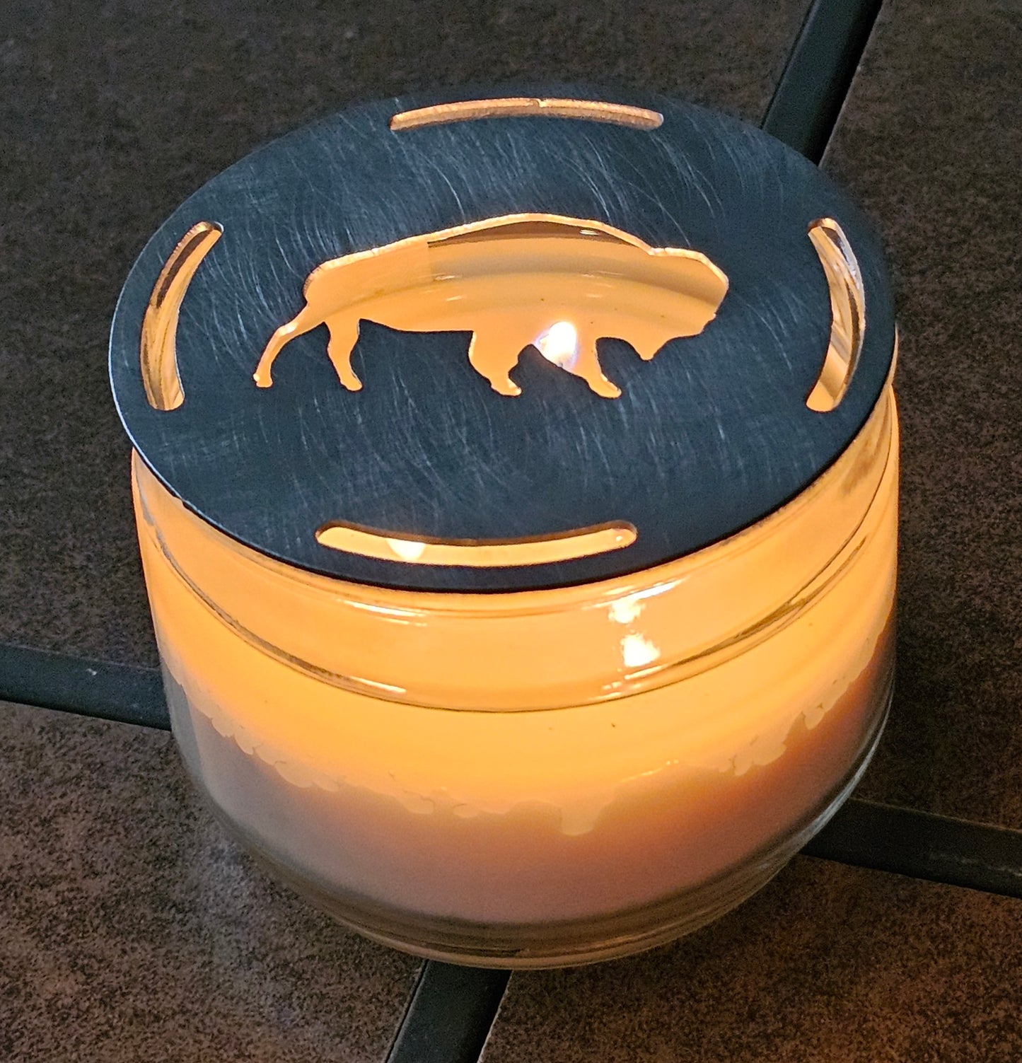 Buffalo candle topper steel lid sitting on glass jar candle