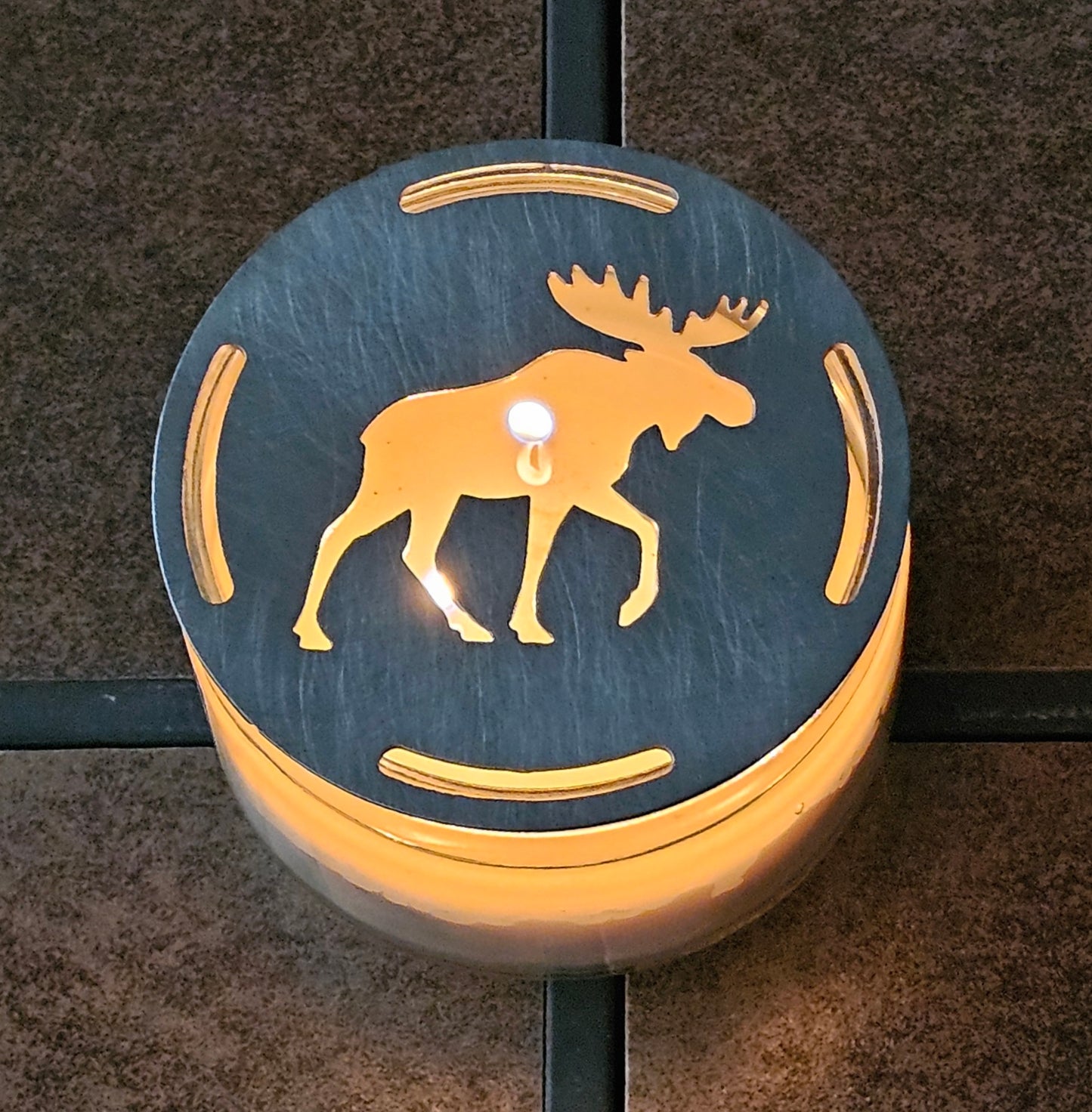 Moose candle topper glowing on lit jar candle, rustic cabin decor candle accessory
