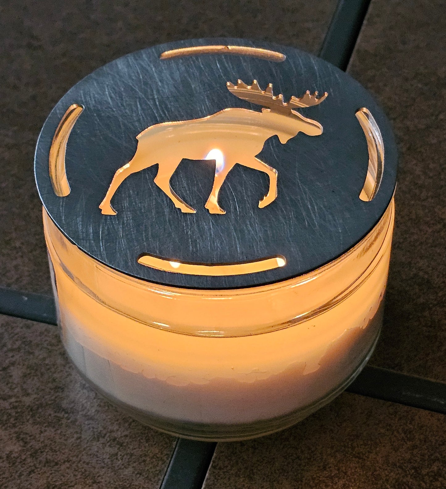 Moose candle topper glowing on lit jar candle, rustic cabin decor candle accessory