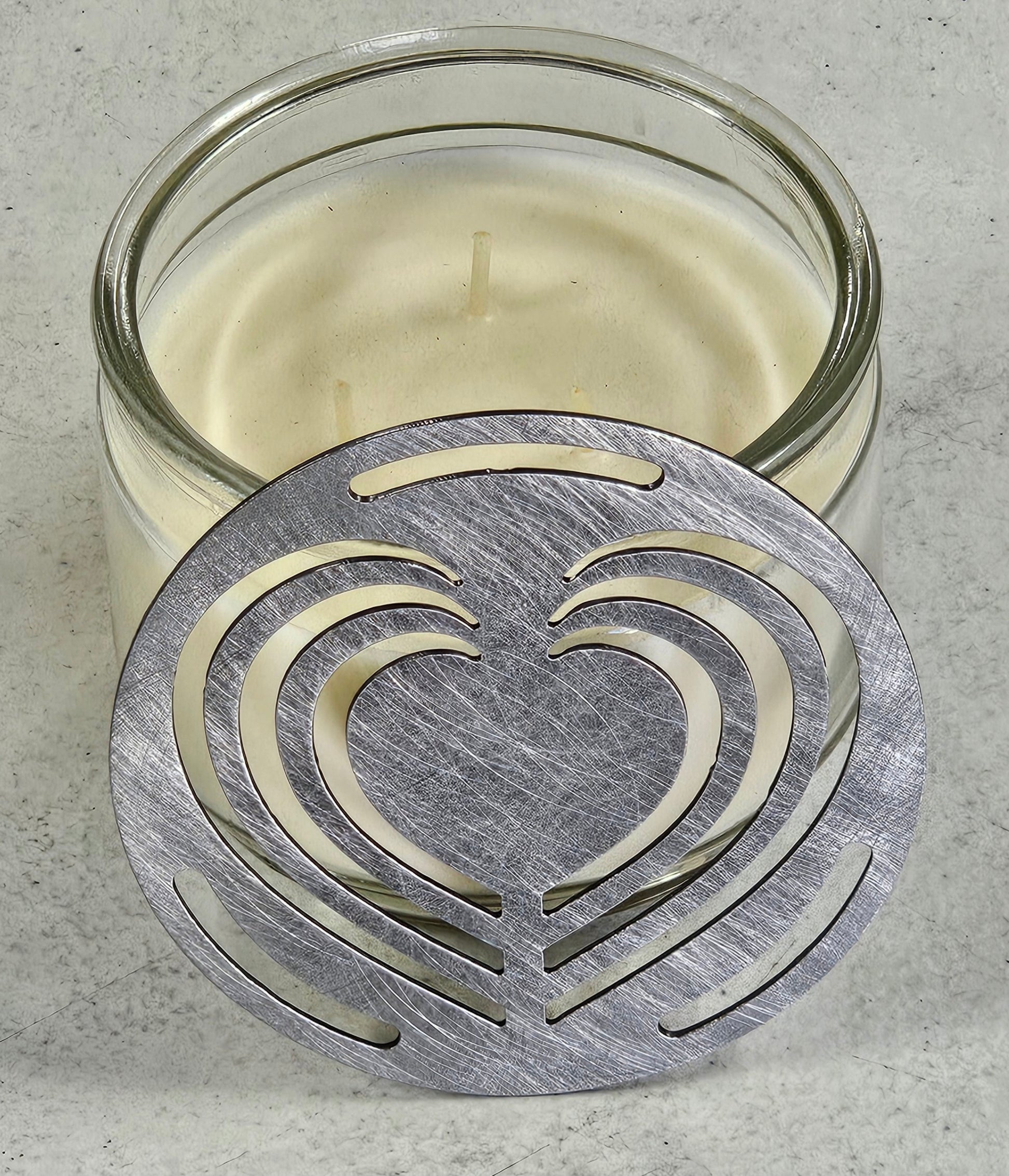 Layered Heart Candle Topper on a white jar candle featuring an elegant decorative metal heart design.