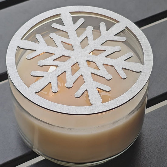 Metal snowflake candle topper on jar candle for Christmas decor