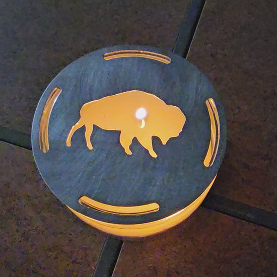 Buffalo candle topper on lit jar candle glowing with bison silhouette